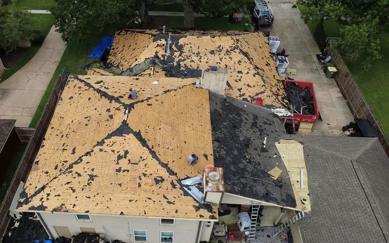 Overhead view of a roof replacement with decking exposed