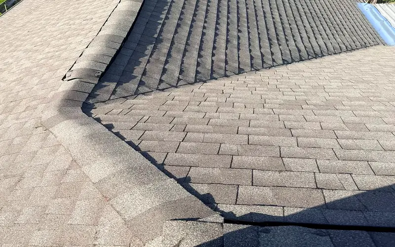 Asphalt shingles and roof ridge shown from above